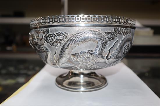 An early 20th century Chinese white metal pedestal bowl, embossed with dragons, 13.5 oz.